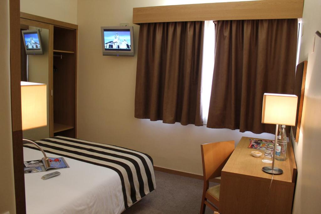 Postel nebo postele na pokoji v ubytování Hotel Principe Lisboa