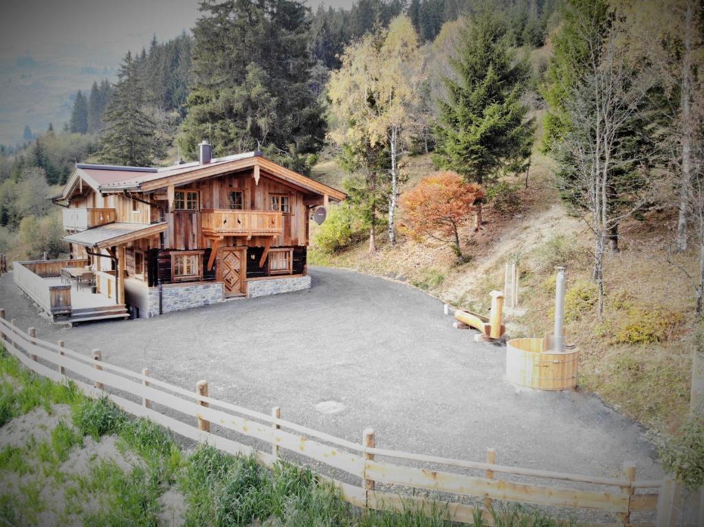 a large house with a driveway in front of it at Almhütte Lengau in Saalbach-Hinterglemm