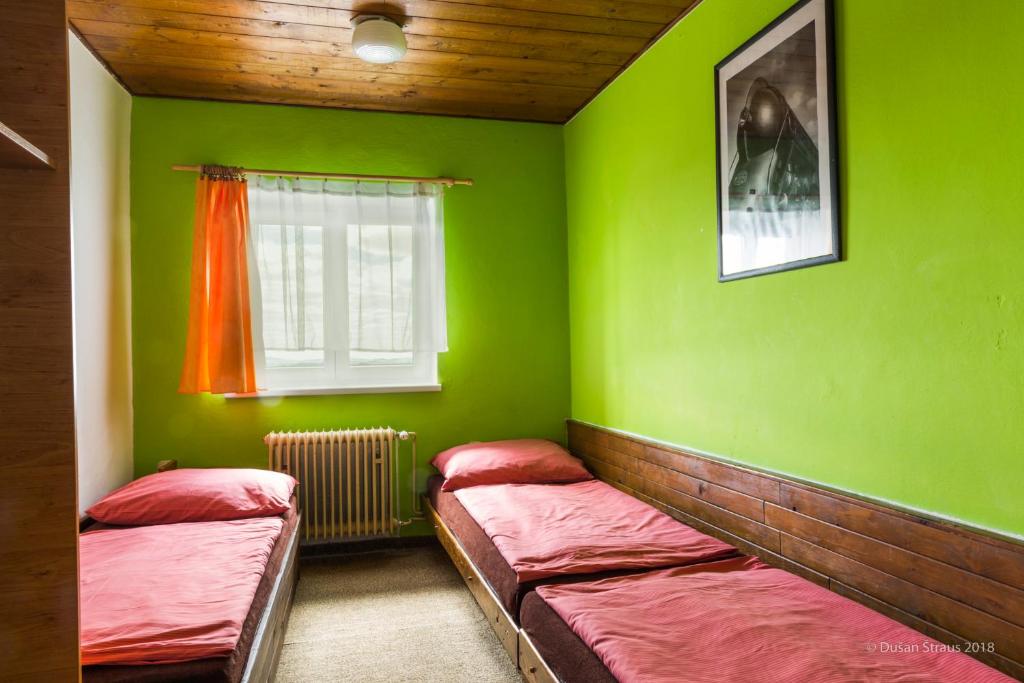Postel nebo postele na pokoji v ubytování Penzion Pohlednička
