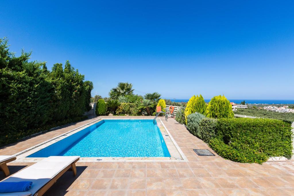 a swimming pool with a view of the ocean at Villa Althaea in Loutra