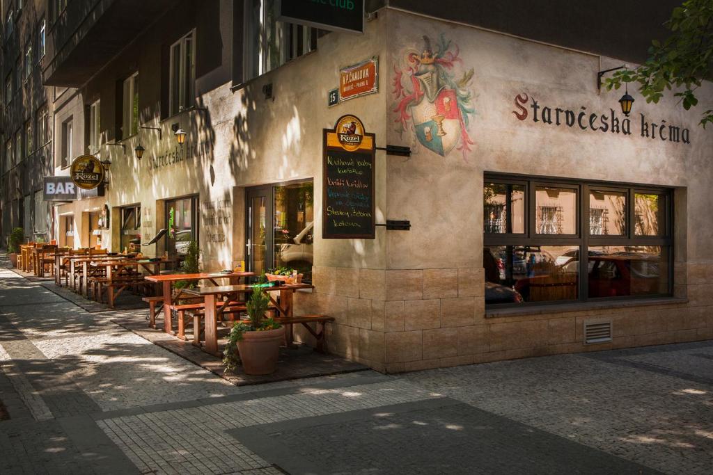 a restaurant with tables and chairs on a street at Hostel Fontána in Prague