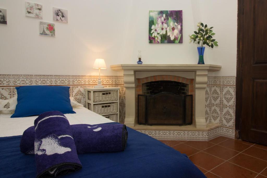 a bedroom with a bed and a fireplace at Casa da Vila Alta in Alenquer