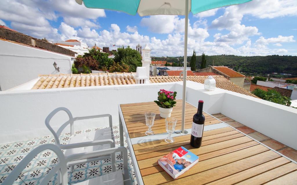 Una botella de vino en el balcón de una casa en Casa Margarida Azul, en Silves