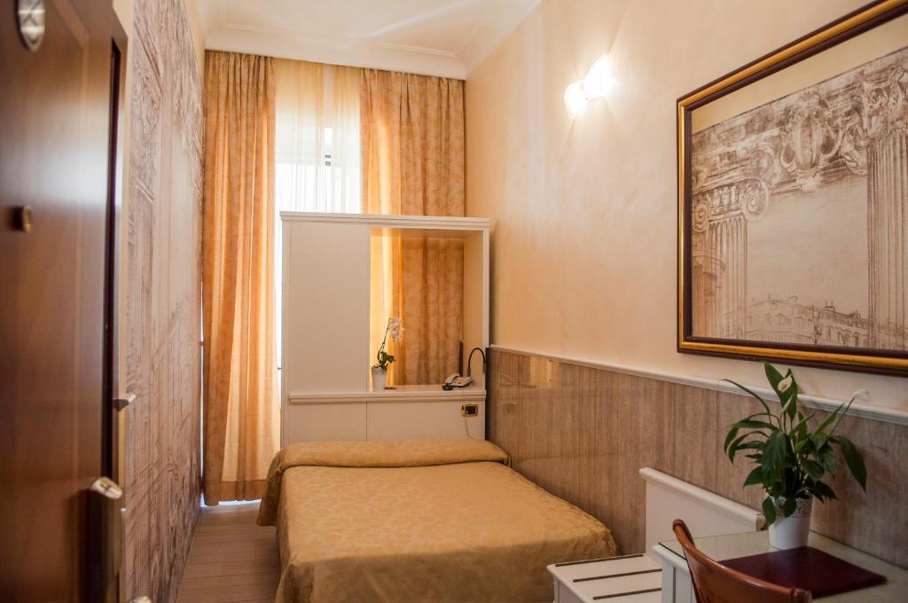 Postel nebo postele na pokoji v ubytování Hotel Palladium Palace