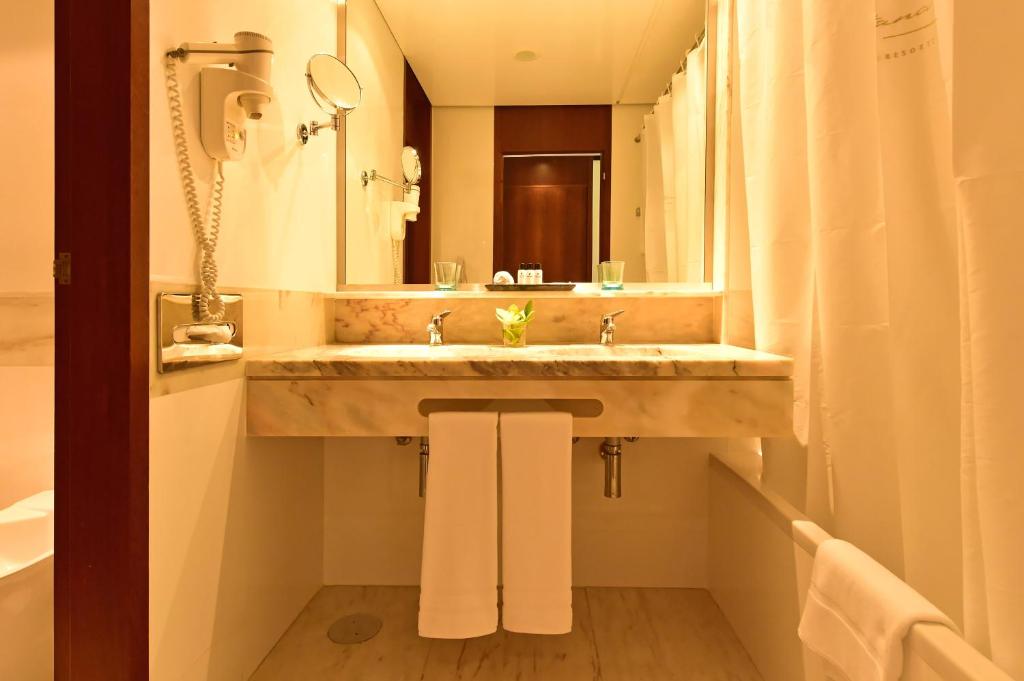 a bathroom with a sink and a mirror at Pestana Casino Park Hotel & Casino in Funchal