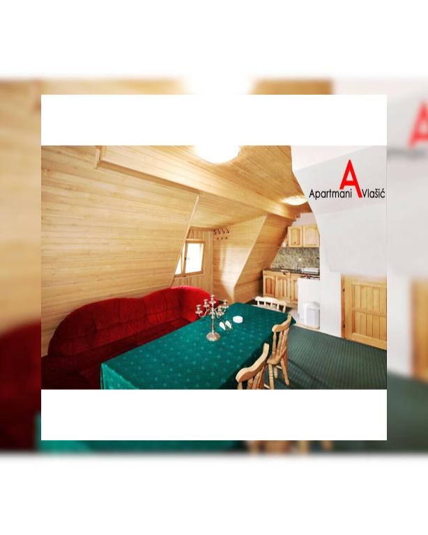 a room with a red couch and a table at Apartments A Vlasic in Vlasic