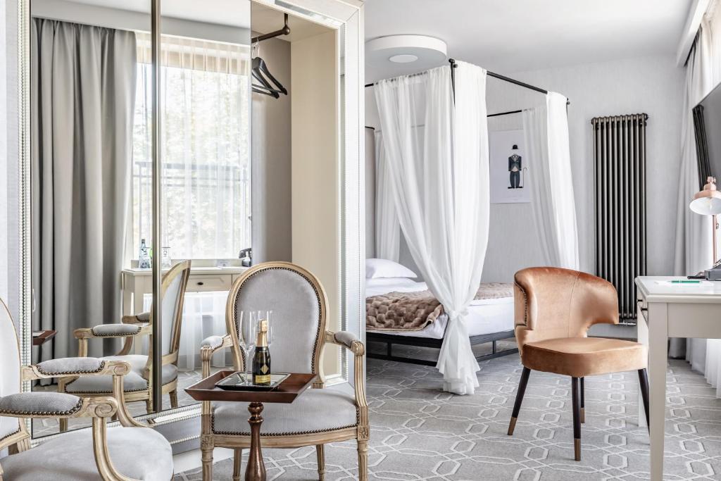 a hotel room with a mirror and a bed at Hotel Traugutta3 in Białystok