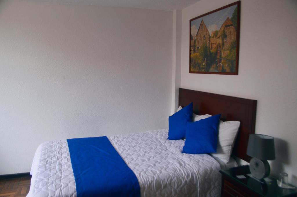 Postel nebo postele na pokoji v ubytování Hostal Alborada Riobamba