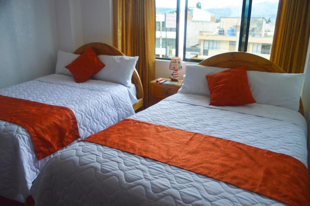 Postel nebo postele na pokoji v ubytování Hostal Alborada Riobamba