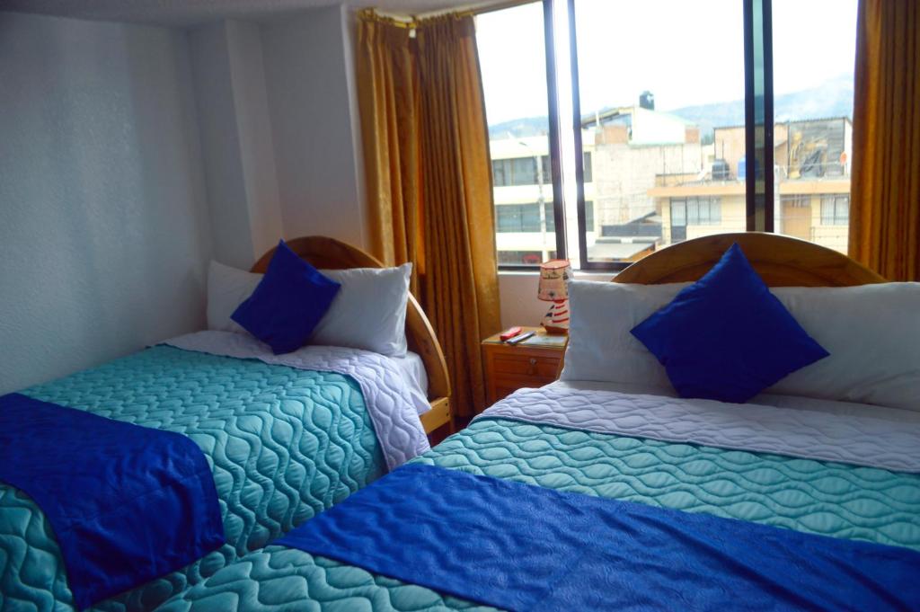 Postel nebo postele na pokoji v ubytování Hostal Alborada Riobamba