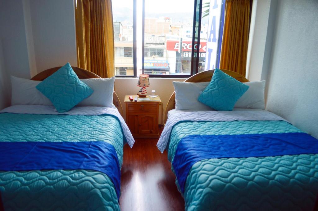 Postel nebo postele na pokoji v ubytování Hostal Alborada Riobamba