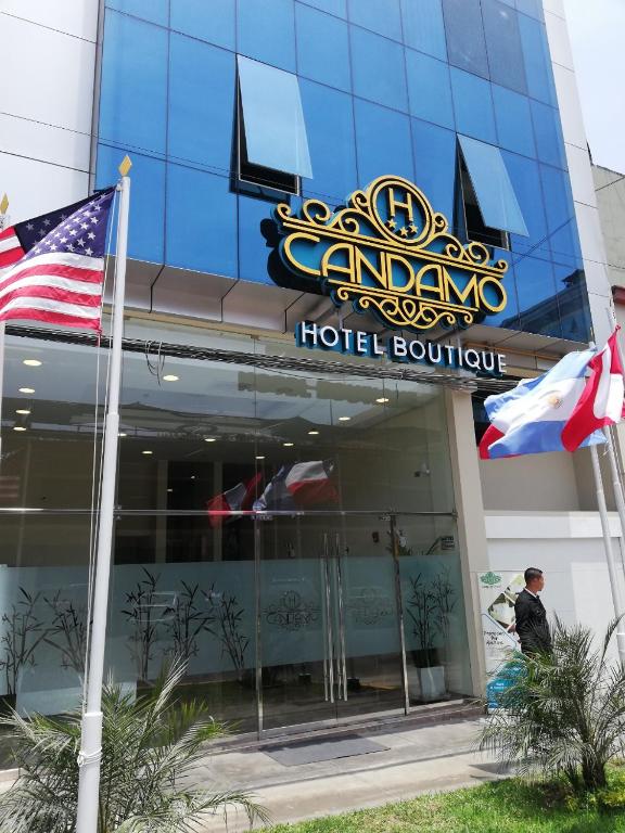 a hotel building with an american flag in front of it at Hotel Boutique Candamo in Lima