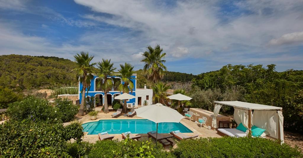 a villa with a swimming pool and a resort at Villa Can Coves in Sant Miquel de Balansat
