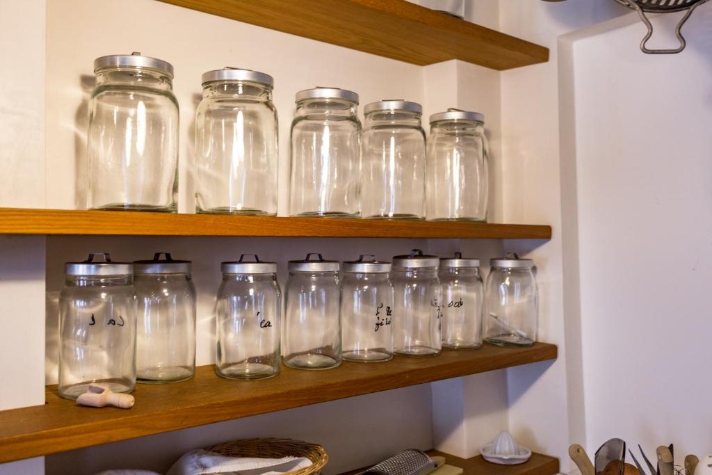 a bunch of glass jars sitting on a shelf at Hotel Tiziano in Venice