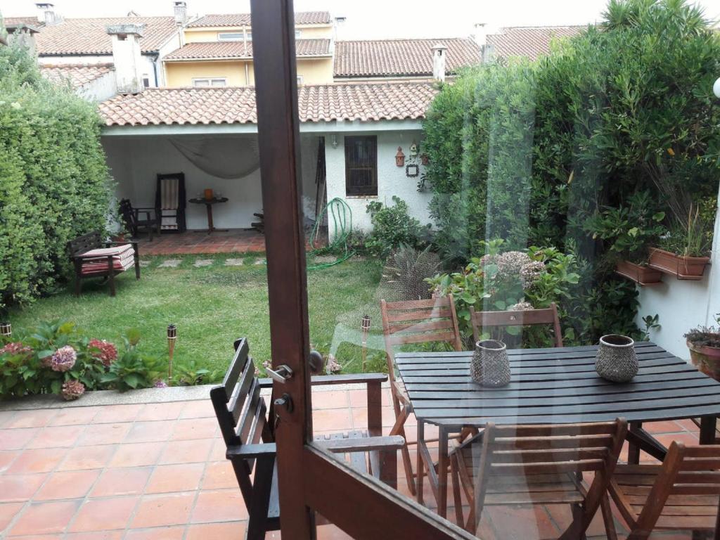 a patio with a table and chairs in a yard at Labruge Ocean View in Labruge