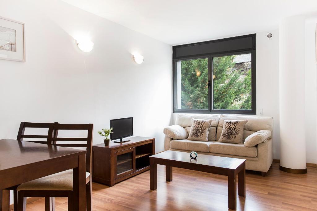 a living room with a couch and a table at Vista Tarter Apartments in El Tarter