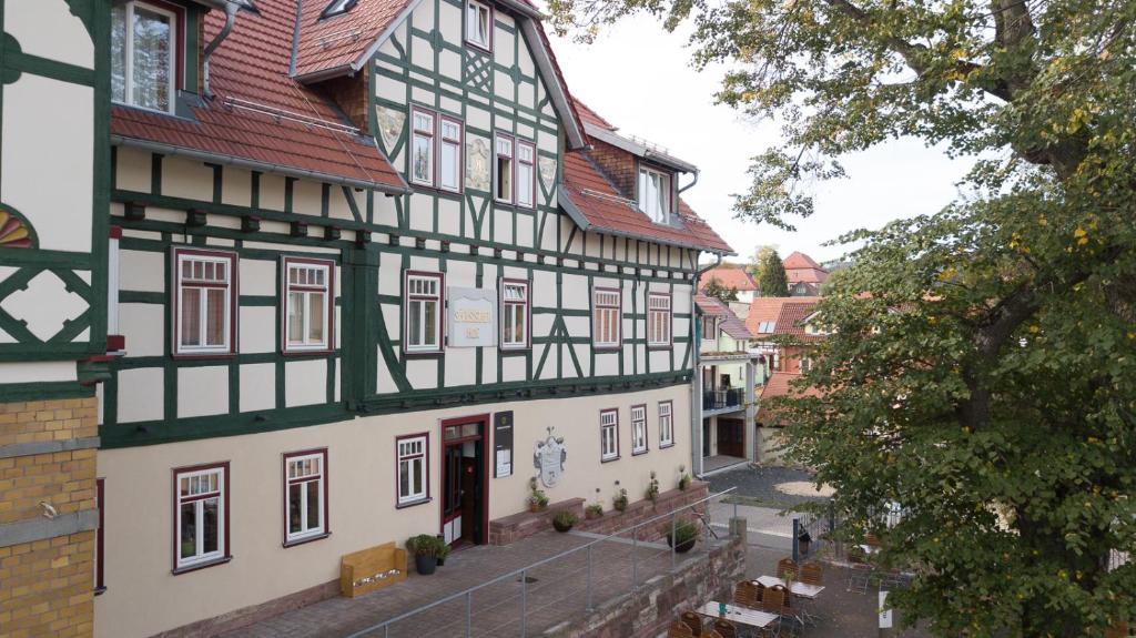 a building with a red and green roof at Hotel Saxenhof in Dermbach