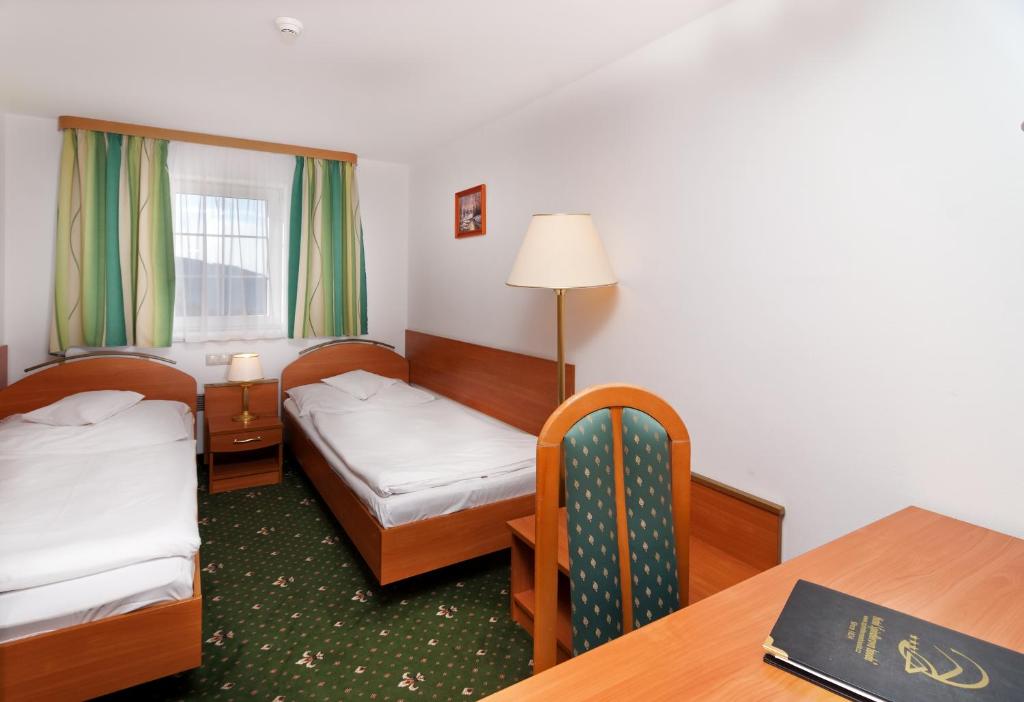 Postel nebo postele na pokoji v ubytování Hotel Spindlerova Bouda