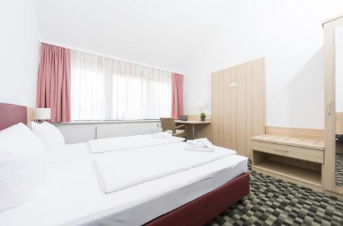 Postel nebo postele na pokoji v ubytování Hotel Saxenhof