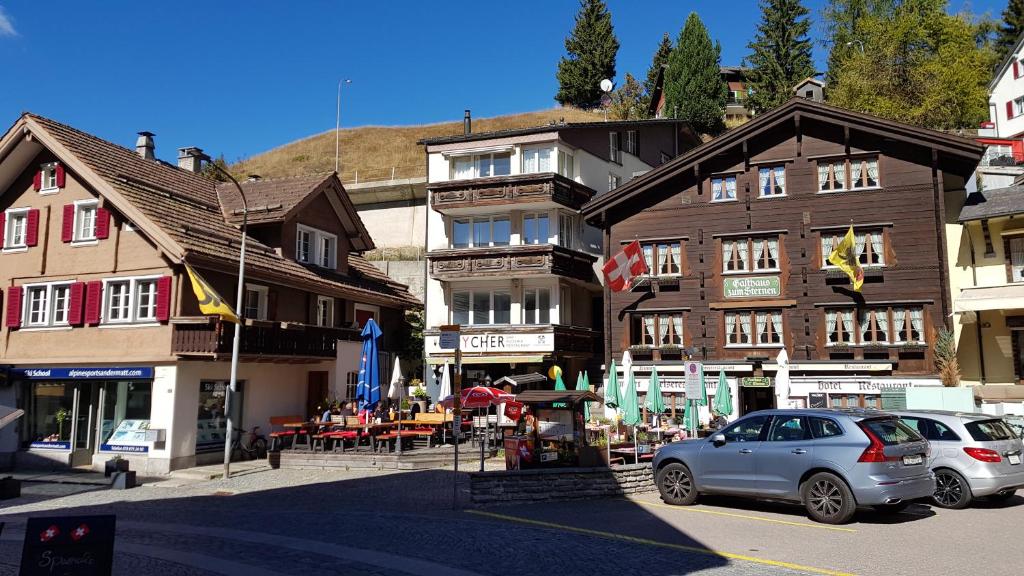 a car is parked in front of a building at 4P Apartment in Andermatt