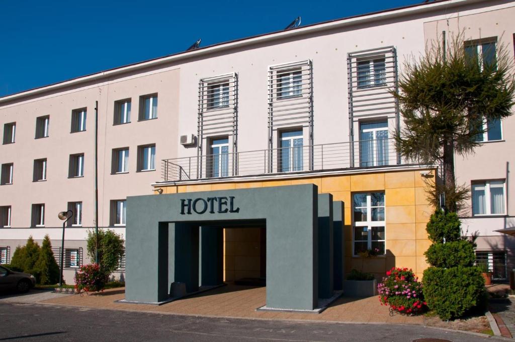 a hotel in front of a large building at Brojan in Jaworzno
