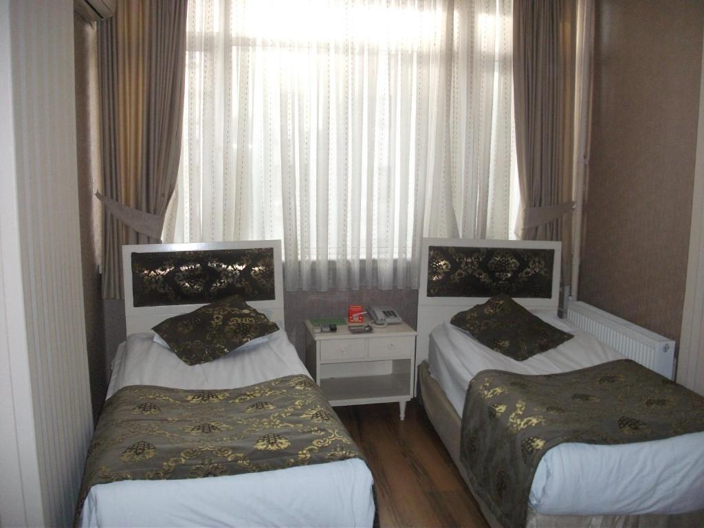 Postel nebo postele na pokoji v ubytování Tac Hotel