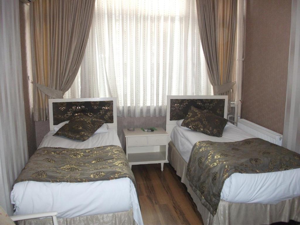 Postel nebo postele na pokoji v ubytování Tac Hotel
