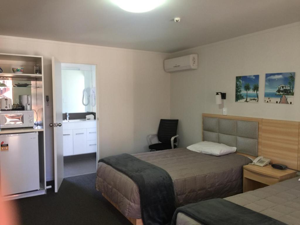 Postel nebo postele na pokoji v ubytování Grosvenor Motel
