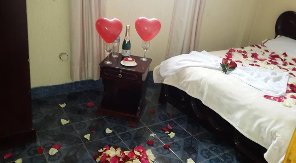 a bedroom with hearts on the floor and a bed at HOSTAL LESLY SALOME in Tulcán