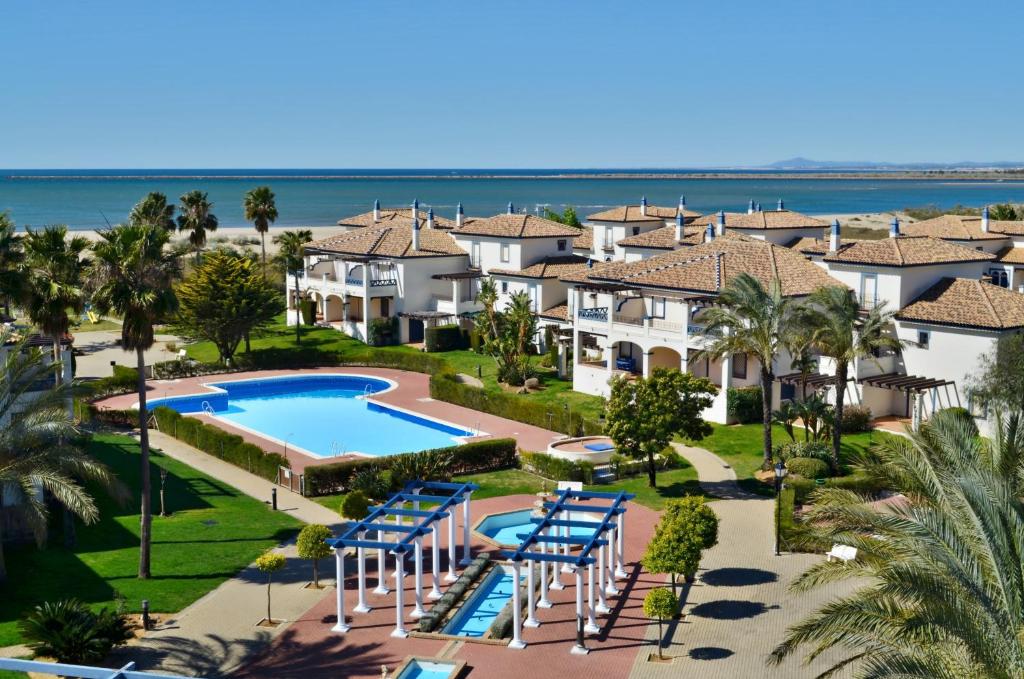 an aerial view of a resort with a pool and houses at Leo San Bruno in Isla Canela