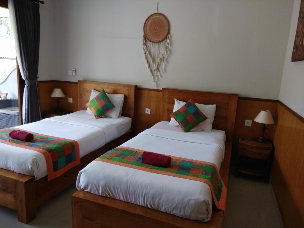 Postel nebo postele na pokoji v ubytování Putu's Paradise Guesthouse