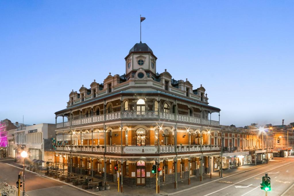 an old building on the corner of a street at The National Hotel in Fremantle