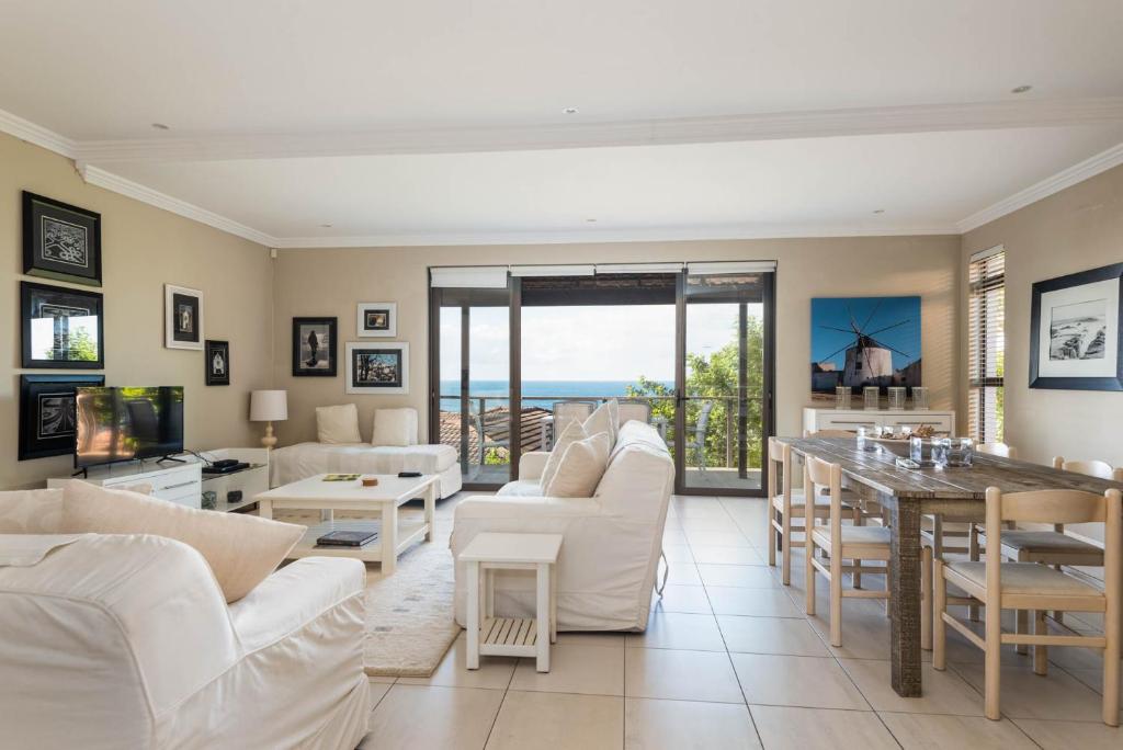 a living room with white furniture and a view of the ocean at Sovereign Sands 2 in KwaDukuza