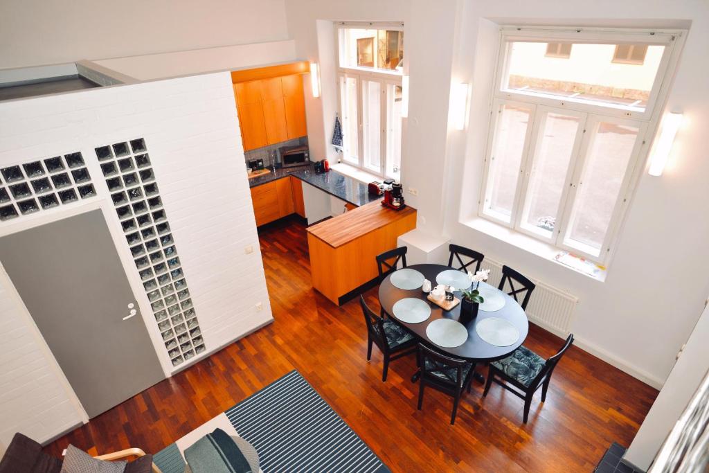 a kitchen and dining room with a table and chairs at Apartment Diana Park in Helsinki