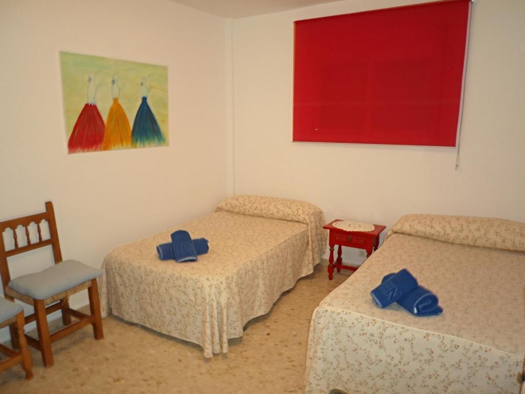 A bed or beds in a room at AGUAMARINA 12 MENYBER