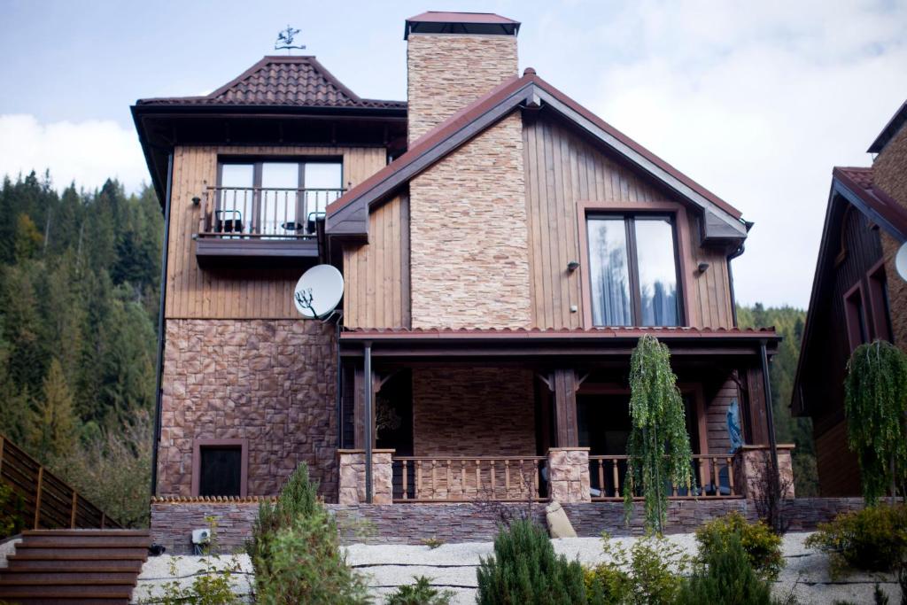 a house with a chimney on top of it at Клуб Яремчанський Шале in Yaremche