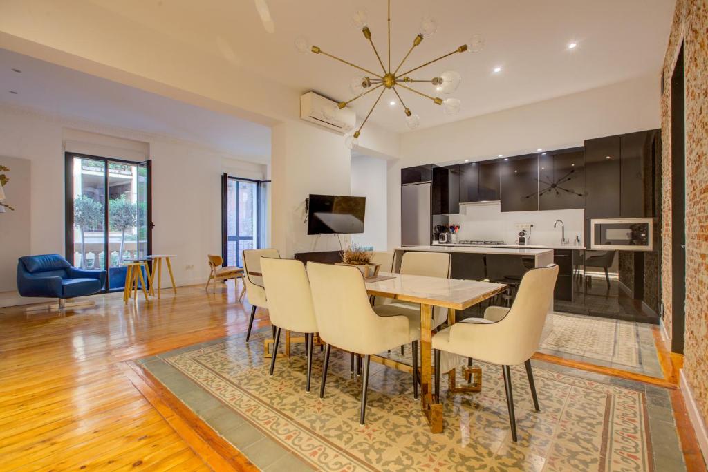 a dining room and living room with a table and chairs at Luxury Rooms Madrid Center in Madrid