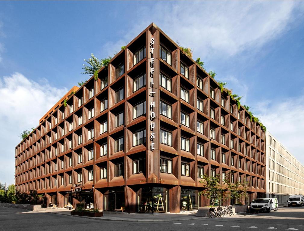 a large brown building with many windows at Steel House Copenhagen in Copenhagen
