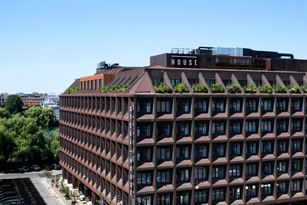 a building with plants on the top of it at Steel House Copenhagen in Copenhagen