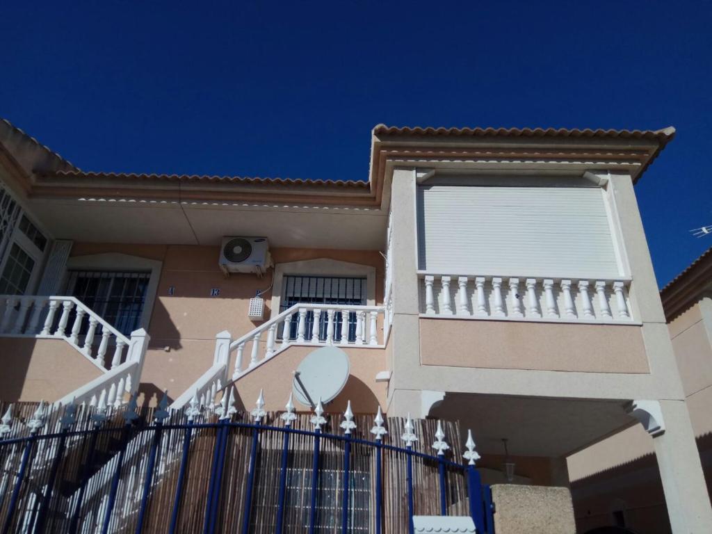 a house with a white fence in front of it at Desconecta a pocos metros de playa y ocio in Los Alcázares