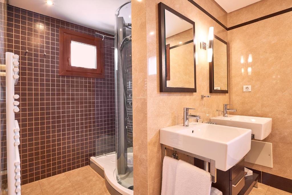 a bathroom with a sink and a toilet and a mirror at Cascade Wellness Resort in Lagos