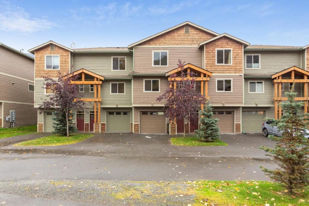 a large apartment building with a parking lot at Glacier Creek in Girdwood