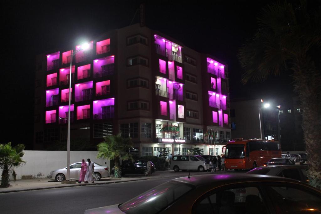 a building with purple lights on the side of it at Nouakchott Hotel in Nouakchott