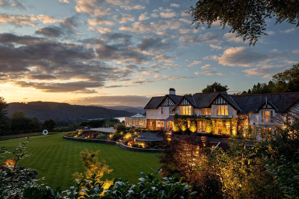 an exterior view of a mansion with lights at Linthwaite House Hotel in Bowness-on-Windermere