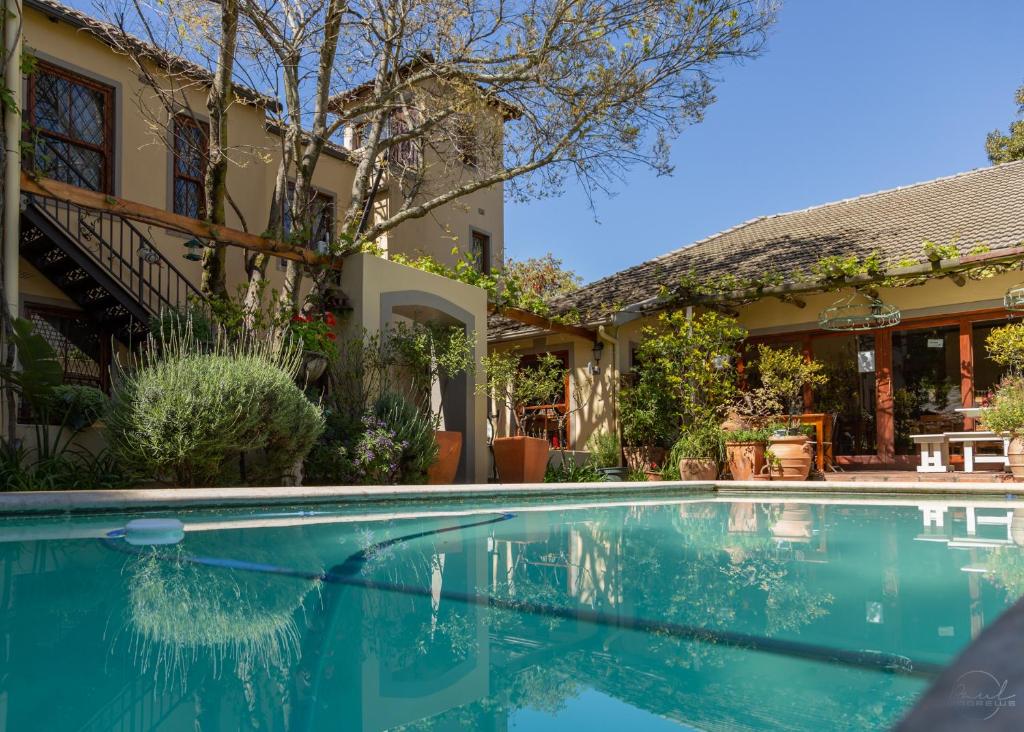 a swimming pool in front of a house at 10 Alexander B&B in Stellenbosch