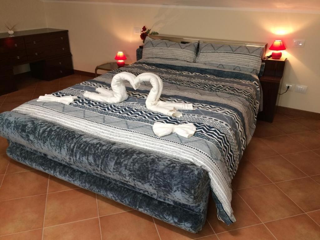 a bedroom with a bed with swans on it at Palidoro House Fiumicino ROMA in Palidoro