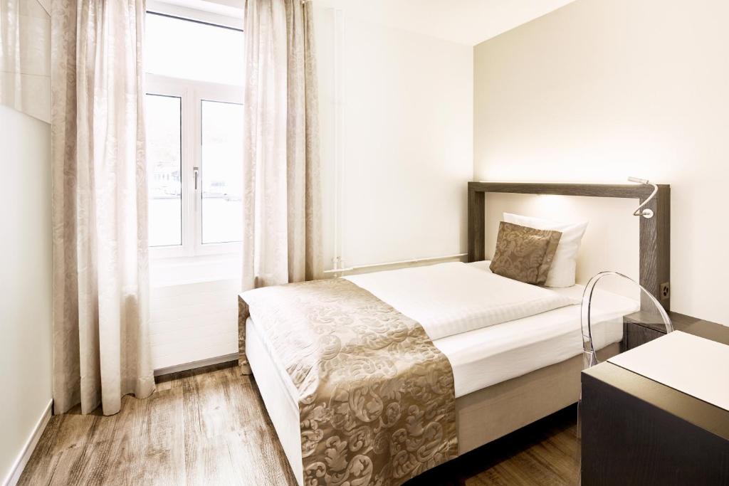 Postel nebo postele na pokoji v ubytování Hotel Schäfli