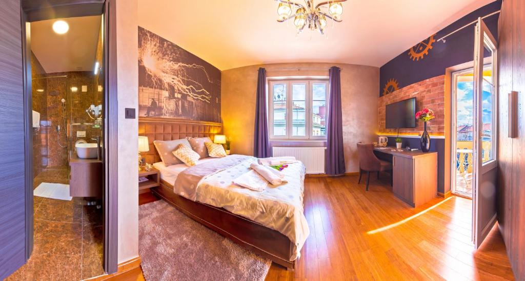 a hotel room with a bed and a television at Seven Stories Rooms, 4th Floor, no elevator in Zagreb