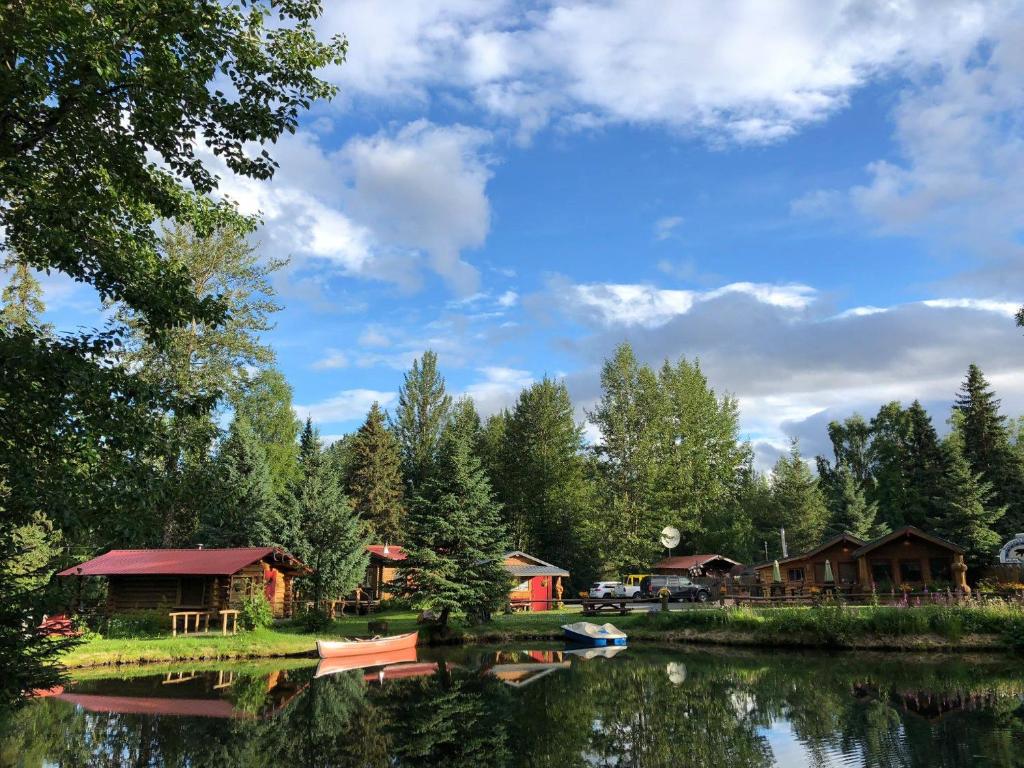 a group of cottages next to a lake at Hope Alaska's Bear Creek Lodge in Hope