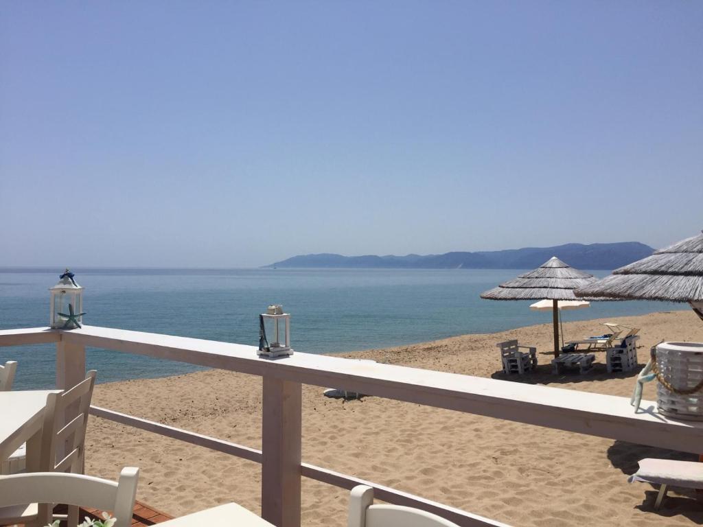 a view of a beach with umbrellas and the ocean at Sa Costera in Orosei